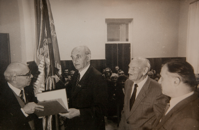 Presentation of the passing AS GSSR Red Banner of the Abkhaz Institute of Language and History on October 18, 1985. In the photo from left to right: representative of the Academy of Sciences of the Georgian SSR, Georgy Dzidzaria, Konstantin Shakryl, Shota Salakaya.