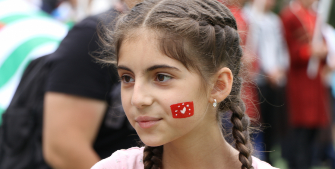 A young representative of the people of Abaza is rooting for her favorite team