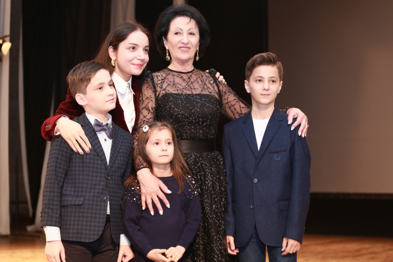Maya Gerzmava with her grandchildren at an evening in honor of her 70th birthday
